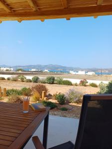 a wooden table with a book and a laptop on it at Campo Suites and Apartments in Kampos Paros