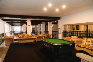 a room with a pool table and couches at Park Club Europe - All Inclusive Resort in Playa de las Americas