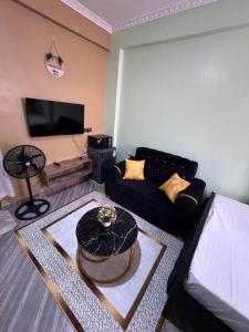 a living room with a couch and a table at H lacasa in Voi