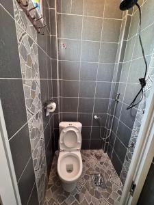 a small bathroom with a toilet in a stall at H lacasa in Voi