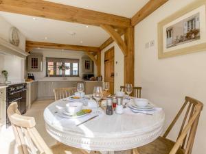 a kitchen and dining room with a white table and chairs at 2 Bed in Newton Tracey oc-80381 in Bishops Tawton