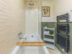 a bathroom with a white tub and a sink at 2 Bed in Newton Tracey oc-80381 in Bishops Tawton +13 photos