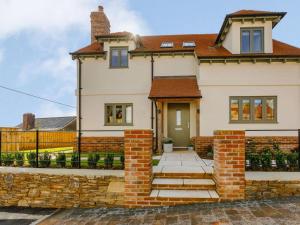 a white house with a brick wall at 2 Bed in Newton Tracey oc-80381 in Bishops Tawton