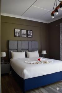 a bedroom with a large bed with a red flower on it at TAG@12A in Piet Retief +90 photos