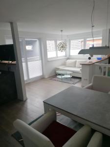 a living room with a couch and a table and chairs at Tinas Fewo 2 in Hohendodeleben +13 photos