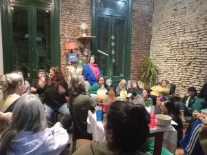 a group of people sitting around a table in a room at Freedom Hostel in Rosario