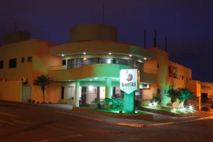 a building with a sign in front of it at Buriti Hotel in Jataí