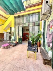 a room with a bench and paintings on the wall at Freedom Hostel in Rosario