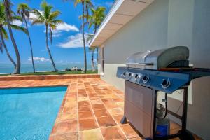 a barbecue grill next to a swimming pool at NEW!Paradise PointVIEWS!Open WaterDockPool! in Marathon