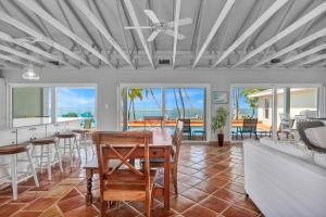 a kitchen and living room with a table and chairs at NEW!Paradise PointVIEWS!Open WaterDockPool! in Marathon