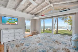 a bedroom with a large bed with a view of the ocean at NEW!Paradise PointVIEWS!Open WaterDockPool! in Marathon +52 photos