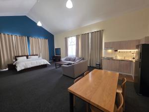 a large hotel room with a bed and a table at Crescent by Oasis in Abu Dhabi