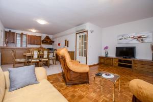 a living room with a couch and a table at Apartments Dionis in Rab