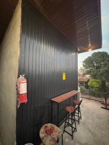 a patio with two chairs and a table and two stools at Evas Inn in General Santos +6 photos