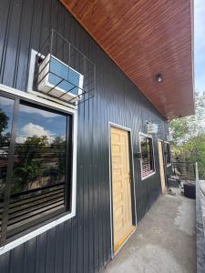 a house with a wooden door and a balcony at Evas Inn in General Santos