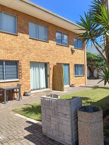 a brick building with a picnic table in front of it at 5 Bayview Gonubie Seaside in Gonubie
