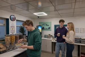 a group of people standing in a kitchen preparing food at Smart Russell Square in London