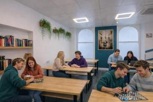 a group of people sitting at tables in a classroom at Smart Russell Square in London