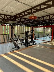 a gym with benches and equipment in a building at Paihappyvillage in Pai