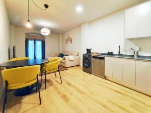 a kitchen and living room with a table and chairs at Apt 1 hab Catedral I, Centro Histórico in Valladolid +18 photos
