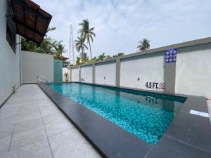 a swimming pool in the side of a building at Desert Beach House with swimming pool in Kuilapayam