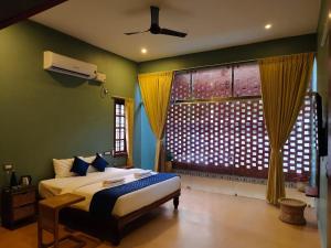 a bedroom with a bed and a large window at Desert Beach House with swimming pool in Kuilapayam +18 photos