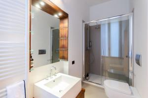 a bathroom with a sink and a toilet and a shower at The Orso Suite -Brera in Milan +17 photos