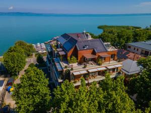 an aerial view of a building with a house at Mala Garden Design Hotel in Siófok