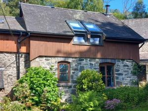 a stone house with a blue window on it at 2 Bed in Machynlleth oc-wad305 in Cemmaes +7 photos