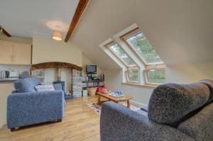 a living room with two chairs and a table at 2 Bed in Machynlleth oc-wad305 in Cemmaes