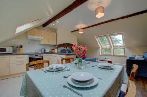 a kitchen and dining room with a table with plates on it at 2 Bed in Machynlleth oc-wad305 in Cemmaes