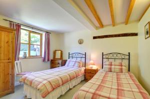 a bedroom with two beds and a window at 2 Bed in Machynlleth oc-wad305 in Cemmaes