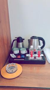 a tray with a tea kettle and a plate on a table at HOTEL Prithvi Ratan in Utrāhtia