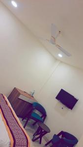 a living room with a table and a chair at HOTEL Prithvi Ratan in Utrāhtia