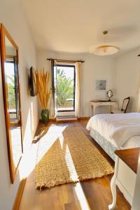a bedroom with a bed and a window and a rug at Kemerbag 29 Guest House 12 Yaş Üstü in Bozcaada +134 photos