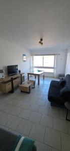 a living room with a couch and a table at port de fecamp in Fécamp