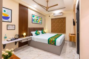 a hotel room with a bed and a desk at Treebo Sri Anand Residency in Chennai +33 photos