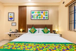 a bedroom with a large bed and a desk at Treebo Sri Anand Residency in Chennai