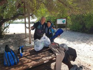 a man and a woman sitting on a bench at Clove Beach in Addu Atoll