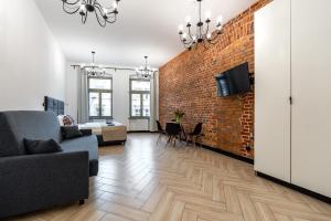 a living room with a brick wall at Pod Błękitnymi Podkowami in Wrocław