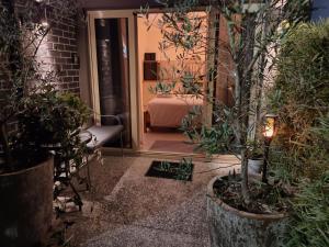 a room with a bed and some potted plants at Executive Studio - Private Parking in Holmview