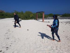 two people playing a game on the beach at Clove Beach in Addu Atoll