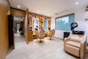 a hair salon with chairs and a mirror at The Royal Bihar in Patna