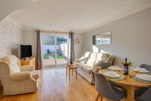a living room with a table and a couch at 2 Bed in Newton oc-bow124 in Porthcawl