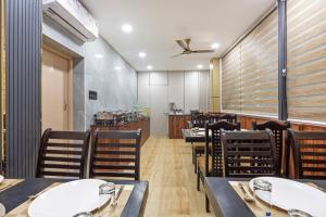 a restaurant with tables and chairs and a ceiling fan at Treebo Sri Anand Residency in Chennai