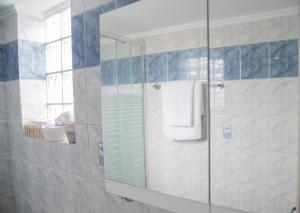 a bathroom with a glass shower with a mirror at anatoli by the sea in Skala Mistegnon +34 photos
