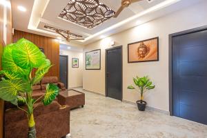a lobby with blue doors and plants at Treebo Sri Anand Residency in Chennai
