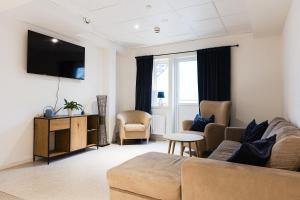 a living room with a couch and a tv at Trossö Vandrarhem in Karlskrona