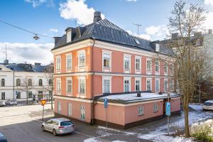 a large orange building with a car parked in front of it at Trossö Vandrarhem in Karlskrona