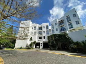 a large white building with a street in front of it at Woodland Tagaytay in Tagaytay